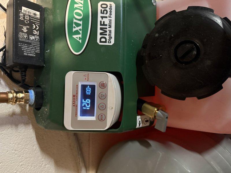 # HVAC Install - Boiler

Completed installation of a combi boiler system with buffer tank integration over a two-day period. The primary unit installed was an AXTON DMF-150 model with digital display and control interface, mounted on a tiled wall in the mechanical room. Established complete copper piping network connecting the boiler to existing plumbing infrastructure, including proper valve placement for system isolation and maintenance access.

Integrated a blue expansion vessel to maintain proper system pressure and accommodate thermal expansion. Connected the buffer tank (green cylindrical unit) to the combi boiler system using brass fittings and appropriate piping configurations to ensure optimal heat distribution and system efficiency. The buffer tank features digital temperature monitoring with LED display showing real-time system readings.

Installed electrical components including power transformer with indicator light for system status monitoring. Routed and secured all elec