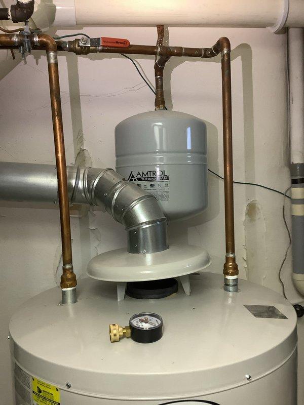 Completed residential water heater system evaluation and component replacement. Installed new AMTROL expansion tank to provide thermal expansion protection for the hot water system. Replaced pressure reducing valve to ensure proper water pressure regulation throughout the residence. Addressed corroded piping components identified during inspection, with significant green oxidation noted on horizontal pipe sections indicating moisture exposure and age-related deterioration. Provided comprehensive estimate for complete water heater replacement based on current system condition and observed wear patterns. All copper piping connections secured with appropriate fittings and valves for optimal system performance and safety compliance.