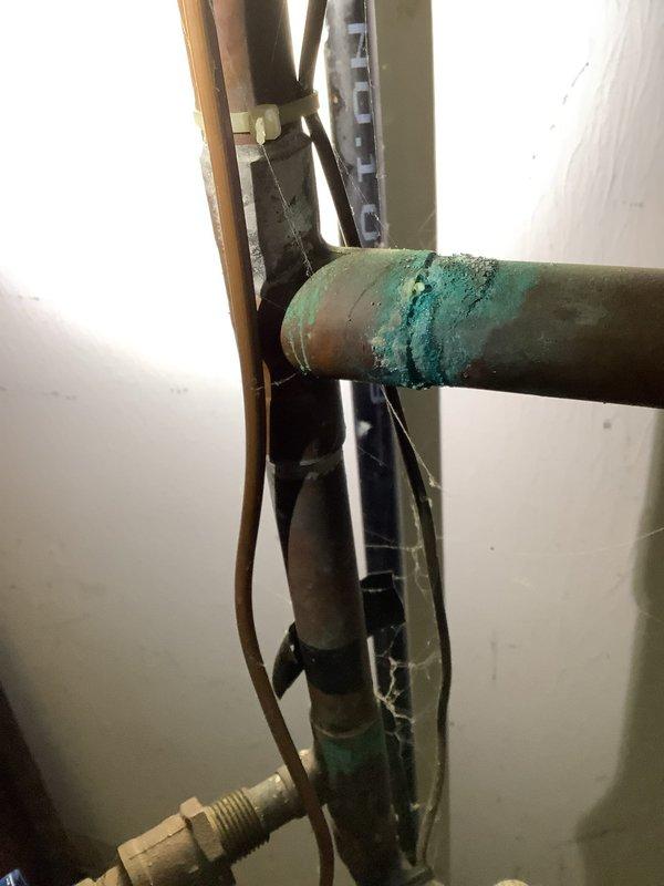 Completed residential water heater system evaluation and component replacement. Installed new AMTROL expansion tank to provide thermal expansion protection for the hot water system. Replaced pressure reducing valve to ensure proper water pressure regulation throughout the residence. Addressed corroded piping components identified during inspection, with significant green oxidation noted on horizontal pipe sections indicating moisture exposure and age-related deterioration. Provided comprehensive estimate for complete water heater replacement based on current system condition and observed wear patterns. All copper piping connections secured with appropriate fittings and valves for optimal system performance and safety compliance.