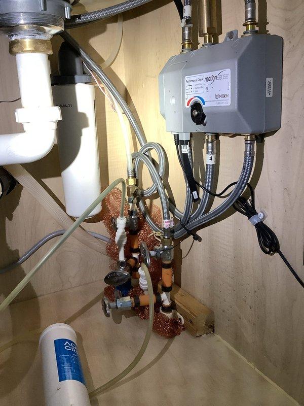 Replaced leaking refrigerator water line shutoff valve located under the kitchen sink. The defective valve had previously caused water damage to the cabinet area, which had been cleaned up prior to service. Installed new valve and verified proper operation with no leaks detected upon completion.