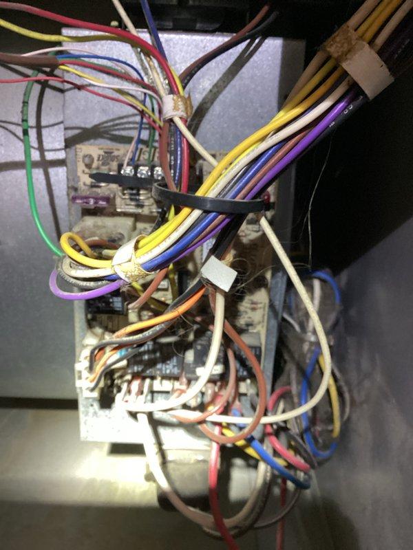 Responded to service call for 30+ year old natural gas furnace that was squealing and subsequently stopped operating. Accessed property using provided entry code as tenant was not home. Performed diagnostic inspection of furnace components and control systems. Examined electrical control board, wiring harness, and connections for signs of failure or deterioration. Inspected heat exchanger coils and associated mechanical components. Documented equipment condition through photographs showing control board with multiple wire connections, manufacturer specification labels with model and serial number information, and internal mechanical components including heat exchanger coils. Service waived as part of MVP membership enrollment.