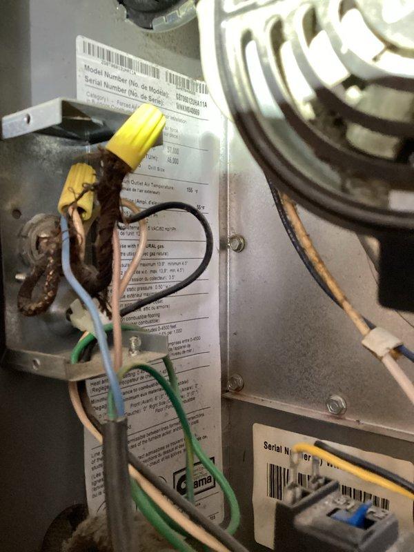 Responded to service call for 30+ year old natural gas furnace that was squealing and subsequently stopped operating. Accessed property using provided entry code as tenant was not home. Performed diagnostic inspection of furnace components and control systems. Examined electrical control board, wiring harness, and connections for signs of failure or deterioration. Inspected heat exchanger coils and associated mechanical components. Documented equipment condition through photographs showing control board with multiple wire connections, manufacturer specification labels with model and serial number information, and internal mechanical components including heat exchanger coils. Service waived as part of MVP membership enrollment.