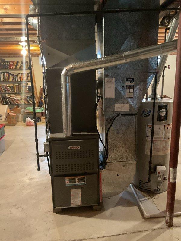Completed scheduled furnace tune-up on Lennox heating system in basement mechanical room. Performed comprehensive maintenance inspection including electrical amp draw testing, which measured 49 amps during operation. Verified all system components functioning properly, inspected ductwork connections, and confirmed unit operating within manufacturer specifications.