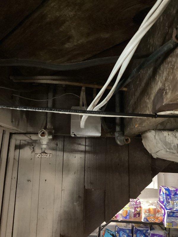 Addressed electrical safety hazards in basement by properly securing open splices and installing code-compliant covers on junction boxes that were previously exposed. All electrical connections were verified for proper termination and boxes were secured to structural members per NEC requirements.