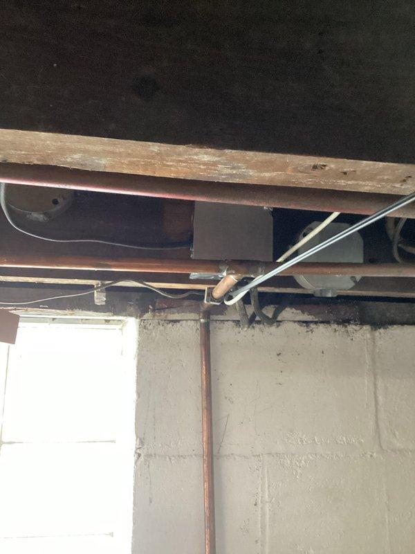 Addressed electrical safety hazards in basement by properly securing open splices and installing code-compliant covers on junction boxes that were previously exposed. All electrical connections were verified for proper termination and boxes were secured to structural members per NEC requirements.