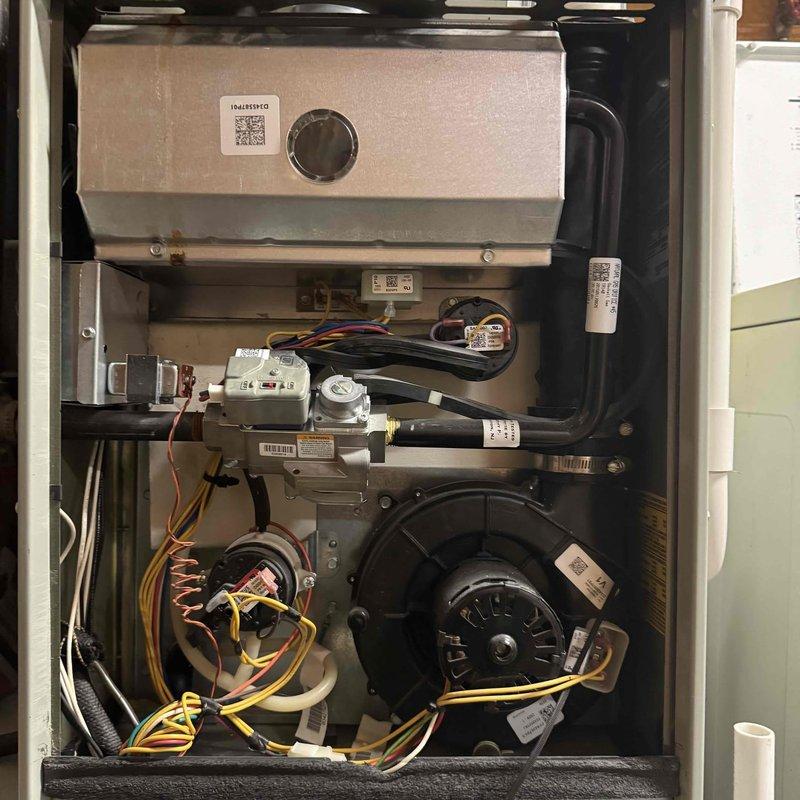 # HVAC Service Call - No Heat Condition

Responded to no heat call on 10-year-old furnace system. Upon arrival, confirmed unit was not producing heat. Removed access panel and performed visual inspection of internal components and control systems.

Examined blower assembly, motor connections, and electrical wiring throughout the unit. All wire connections appeared secure with no visible signs of damage or loose terminals. Inspected control board circuitry and digital display interface, which was operational and showing diagnostic information. 

Evaluated pressure switches, safety sensors, and flame sensing components for proper operation. Checked all visible safety interlocks and control sequences. Reviewed system configuration on digital control panel to verify proper programming and thermostat communication.

Inspected heat exchanger area and internal airflow pathways for obstructions or damage. Blower wheel showed no signs of debris accumulation that would restrict airflow. All mech