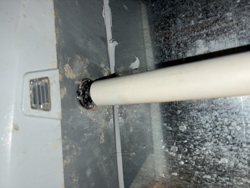 Completed MVP maintenance on both furnace and air conditioning system. Inspected evaporator coil and found heavy accumulation of dust and debris throughout the coil fins, which significantly reduces heat transfer efficiency and system performance. Examined condensate drain line penetration through building structure, noting seal condition and surrounding area for proper drainage function.