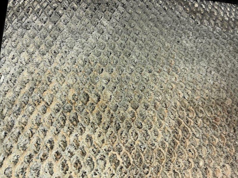 Completed MVP maintenance on both furnace and air conditioning system. Inspected evaporator coil and found heavy accumulation of dust and debris throughout the coil fins, which significantly reduces heat transfer efficiency and system performance. Examined condensate drain line penetration through building structure, noting seal condition and surrounding area for proper drainage function.