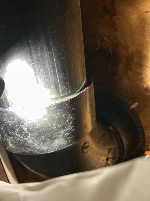 Responded to water leak investigation with ceiling access already opened from previous visit. Documented extensive water damage to subfloor and surrounding areas, including significant staining and deterioration around central penetration point. Inspected attic space and HVAC ductwork above affected area, noting moisture staining on plywood sheathing and aged ductwork components with visible wear. Photographed damaged areas showing concentrated water intrusion pattern on exposed subflooring and compromised building materials. Area requires full damage assessment to determine extent of repairs needed for affected flooring, subfloor, and potential structural components before remediation can proceed.