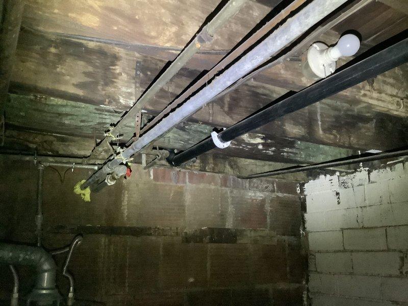 Responded to plumbing concern in kitchen area following recent inspection report. Upon arrival, conducted thorough visual assessment of basement plumbing infrastructure beneath kitchen. Inspected exposed drain lines, supply lines, and pipe connections throughout crawl space. All visible PVC drain piping, joints, and connections were examined for signs of leaks, damage, or code violations. Documented existing conditions with photographs showing plumbing system configuration and structural elements. No active leaks or immediate failures were observed during inspection. Advised property owner of findings and recommended follow-up regarding specific concerns noted in previous inspection report.