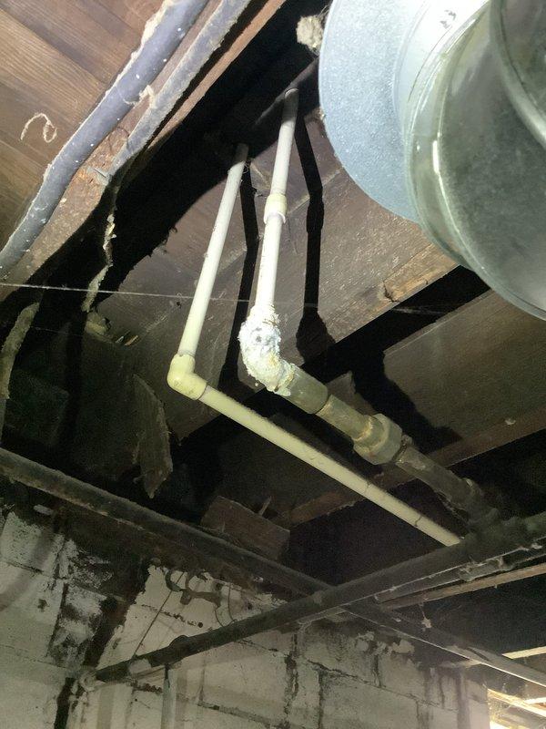 Responded to plumbing concern in kitchen area following recent inspection report. Upon arrival, conducted thorough visual assessment of basement plumbing infrastructure beneath kitchen. Inspected exposed drain lines, supply lines, and pipe connections throughout crawl space. All visible PVC drain piping, joints, and connections were examined for signs of leaks, damage, or code violations. Documented existing conditions with photographs showing plumbing system configuration and structural elements. No active leaks or immediate failures were observed during inspection. Advised property owner of findings and recommended follow-up regarding specific concerns noted in previous inspection report.