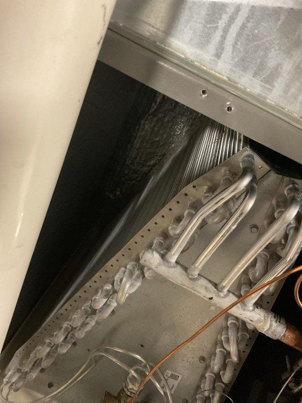 Completed MVP cooling maintenance visit and discovered evaporator coil with extensive ice buildup. Diagnosed frozen coil condition, documented system status with photos, and addressed the issue to restore proper cooling operation.