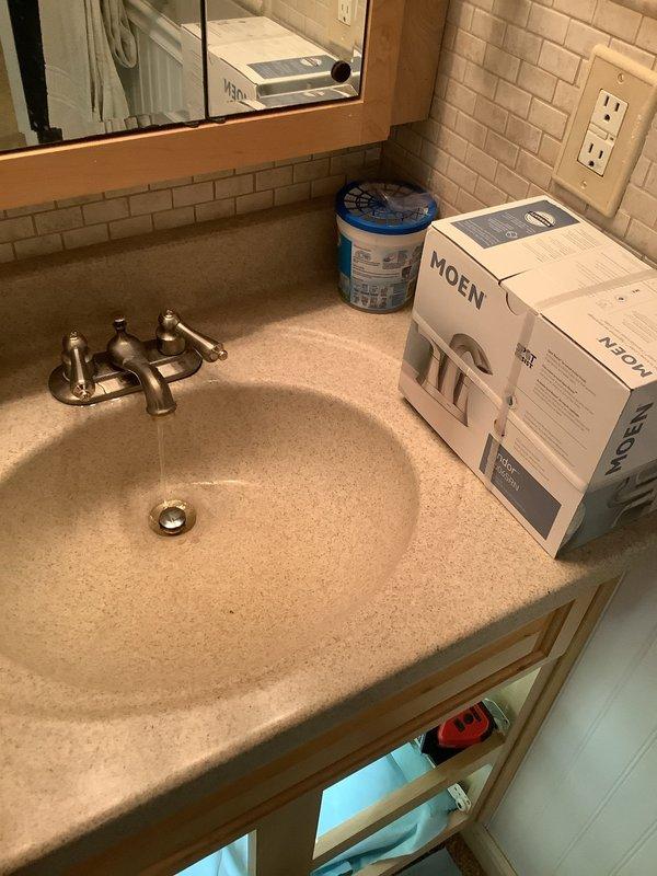 Completed multi-location plumbing fixture replacement and repair service. Installed customer-supplied kitchen faucet with new angle stop shut-off valves and supply lines beneath cabinet. Replaced basement lavatory faucet with customer-supplied unit, including installation of new shut-off valves and supply lines. Performed repairs on second-floor hallway bathroom, replacing the lavatory S-trap assembly and installing new flush valve seal in American Standard Champion toilet. All fixtures tested for proper operation and verified leak-free connections upon completion.