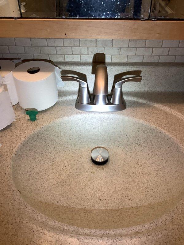Completed multi-location plumbing fixture replacement and repair service. Installed customer-supplied kitchen faucet with new angle stop shut-off valves and supply lines beneath cabinet. Replaced basement lavatory faucet with customer-supplied unit, including installation of new shut-off valves and supply lines. Performed repairs on second-floor hallway bathroom, replacing the lavatory S-trap assembly and installing new flush valve seal in American Standard Champion toilet. All fixtures tested for proper operation and verified leak-free connections upon completion.