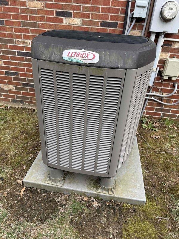 Performed scheduled maintenance on a 4-year-old Lennox heat pump system. Inspected outdoor unit exterior, which showed weathering and algae buildup on top panel and housing. Accessed electrical control panel and verified all wire connections, circuit board components, and capacitor were secure and functioning properly. System operational upon completion of maintenance inspection.