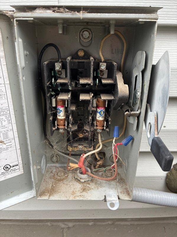 Completed MVP recurring cooling maintenance visit on residential air conditioning system. Performed comprehensive inspection of outdoor condensing unit, verified proper fan operation, and examined electrical disconnect box. Inspected fuses and electrical connections, noting accumulated debris and aging components within disconnect enclosure. Unit operational at time of service completion.