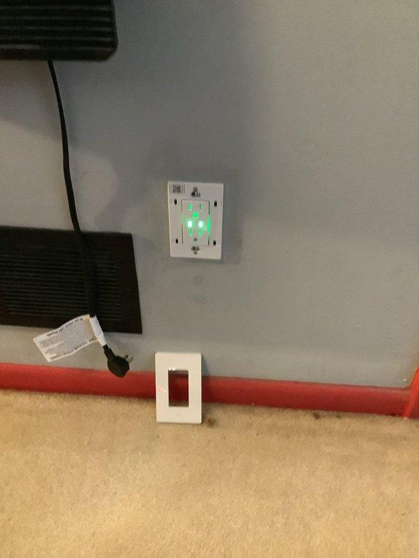 Removed two existing wall switches per customer request and installed customer-supplied smart outlet in residential location. Replaced standard duplex receptacle with programmable smart outlet featuring timer controls and indicator lights, verified proper wiring connections and tested device functionality to ensure proper operation.