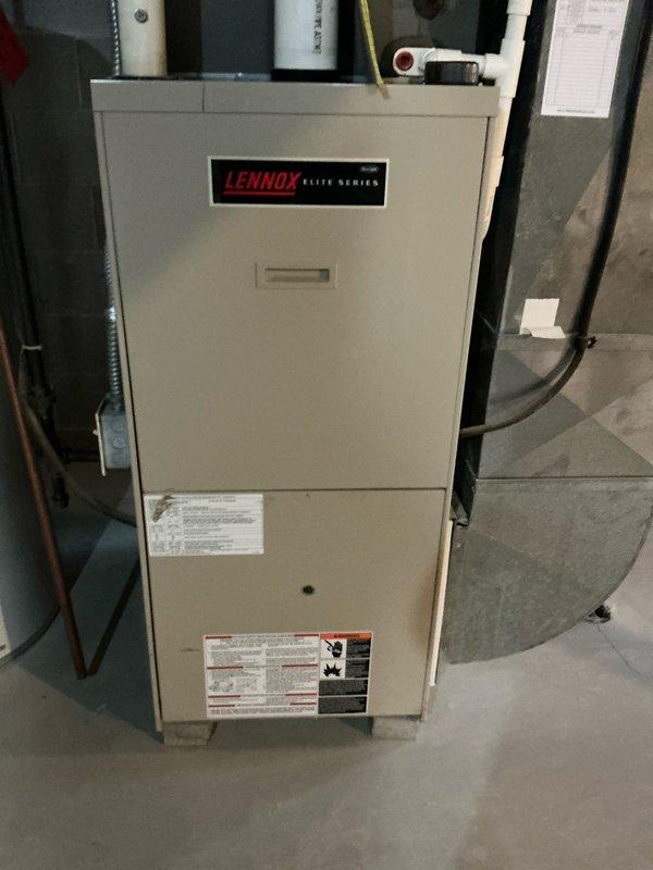 Conducted on-site evaluation of existing 26-year-old furnace system for replacement estimate. Assessed current Lennox Elite Series heating unit installation in basement location, documenting equipment condition, ductwork configuration, venting system with PVC exhaust pipes, electrical connections via armored conduit, gas line routing, and existing plenum assembly to provide accurate replacement specifications and scope of work.