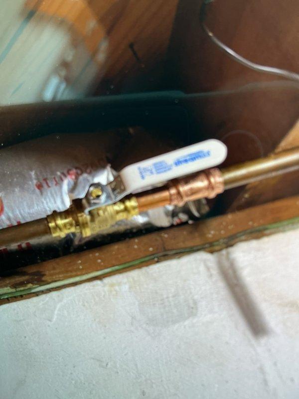 Cut and removed existing 2" galvanized drain line in second floor bathroom wall. Adapted connection with new PVC fitting and 90-degree elbow, then reduced to 1-1/2" using bushing. Installed new Desanco fitting to accommodate existing 1-1/4" tubular trap from sink fixture. Installed new 1/2" ball valve for exterior spigot connection. All connections tested and verified leak-free upon completion.