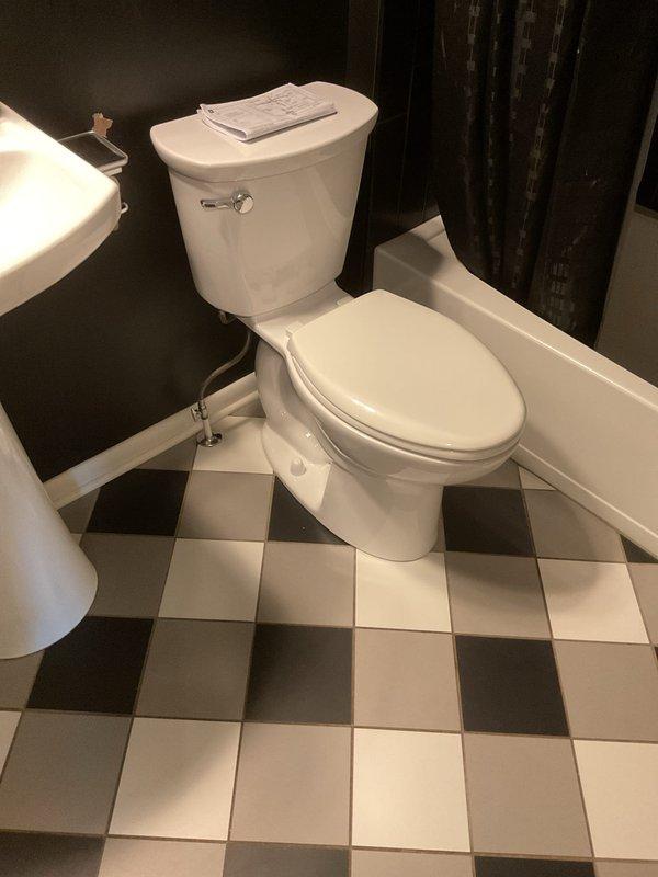 Responded to toilet leak caused by cracked tank after customer leaned against it. Replaced damaged unit with new American Standard Cadet PRO two-piece toilet featuring right-height elongated bowl and slow-close seat. Ordered necessary parts and completed installation upon arrival, restoring full functionality to bathroom fixture.