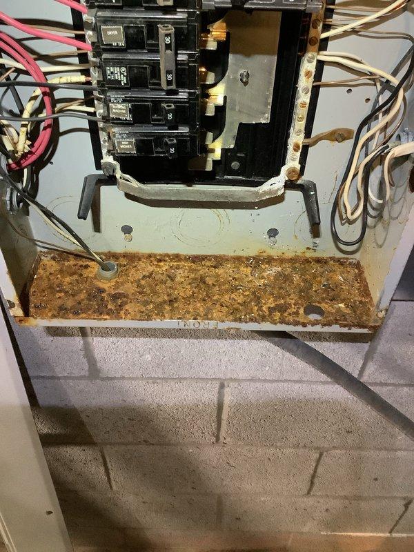 Responded to service call for non-functioning kitchen outlets. Upon arrival, found GFI outlet requiring replacement along with three additional outlets without power. Inspected electrical panel and discovered severe rust and corrosion on main breaker base plate, indicating moisture intrusion that compromised electrical connections. Replaced defective GFI outlet and restored power to affected circuits. Documented extensive panel corrosion for future remediation, as deteriorated condition poses potential safety hazard requiring panel replacement or comprehensive repair.