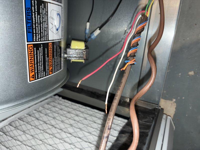 Completed recurring preventive maintenance on residential air conditioning system. Performed comprehensive inspection of HVAC unit components including electrical connections, refrigerant lines, and filtration system. Inspected copper refrigerant tubing for proper condition and connections, verified electrical wiring integrity across multiple circuits, and examined system labels and safety warnings for compliance. Evaluated air filter condition and documented significant dust and debris accumulation on mesh filter material, indicating need for replacement to maintain optimal airflow and system efficiency.