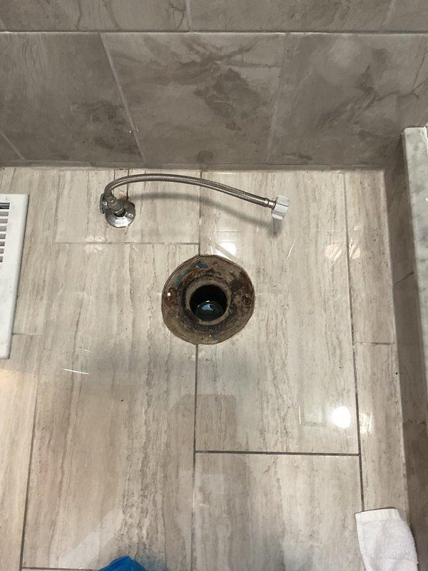 Responded to service call for clogged toilet drain in residential bathroom. Upon arrival, assessed the shower drain system which showed signs of significant corrosion and buildup on the drain fixture. Utilized professional drain clearing equipment to remove obstruction and restore proper drainage flow. Verified water flow through the drain line and confirmed complete clearance of the blockage. System tested and returned to normal operation with no further drainage issues detected.