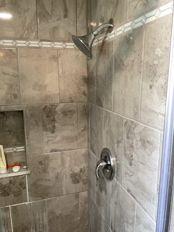 Responded to service call for clogged toilet drain in residential bathroom. Upon arrival, assessed the shower drain system which showed signs of significant corrosion and buildup on the drain fixture. Utilized professional drain clearing equipment to remove obstruction and restore proper drainage flow. Verified water flow through the drain line and confirmed complete clearance of the blockage. System tested and returned to normal operation with no further drainage issues detected.