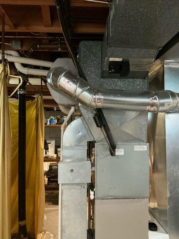 Provided comprehensive estimate for HVAC system replacement including air conditioning unit and tankless water heater installation. Assessed existing Carrier furnace setup in basement utility area, evaluated current ductwork configuration including metallic elbow connections and air handling components, and documented installation space requirements for proposed equipment upgrades.