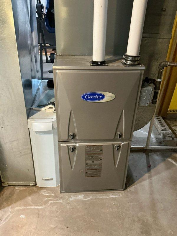 Provided comprehensive estimate for HVAC system replacement including air conditioning unit and tankless water heater installation. Assessed existing Carrier furnace setup in basement utility area, evaluated current ductwork configuration including metallic elbow connections and air handling components, and documented installation space requirements for proposed equipment upgrades.