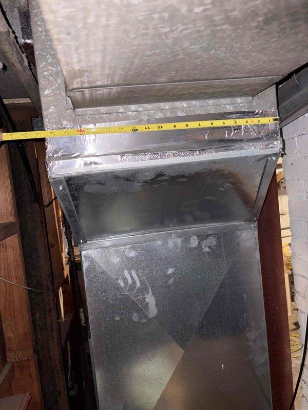 Conducted on-site assessment for mini split system installation to address existing furnace short cycling issues. Evaluated current ductwork configuration and measured existing HVAC infrastructure in basement area, noting significant condensation accumulation on metal ductwork indicating potential humidity concerns. Provided estimate for mini split heating and cooling system as alternative solution to resolve short cycling problem and improve climate control efficiency.