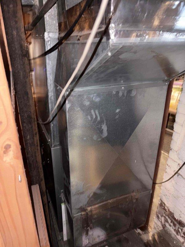 Conducted on-site assessment for mini split system installation to address existing furnace short cycling issues. Evaluated current ductwork configuration and measured existing HVAC infrastructure in basement area, noting significant condensation accumulation on metal ductwork indicating potential humidity concerns. Provided estimate for mini split heating and cooling system as alternative solution to resolve short cycling problem and improve climate control efficiency.