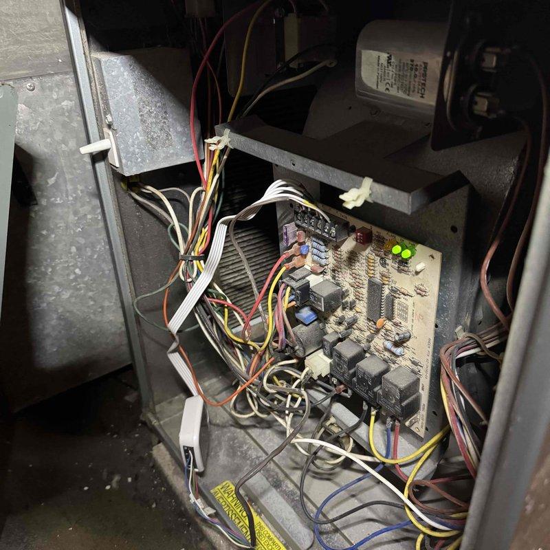 Completed comprehensive tune-up on 15+ year old furnace system. Performed thorough inspection of internal components including control board with operational LED indicators, electrical connections, blower motor assembly, and squirrel cage blower wheel. Assessed wiring harnesses and connections throughout the unit, noting all components secured properly with zip ties. Blower wheel showed typical dust accumulation consistent with system age; all mechanical and electrical components found operational during inspection.