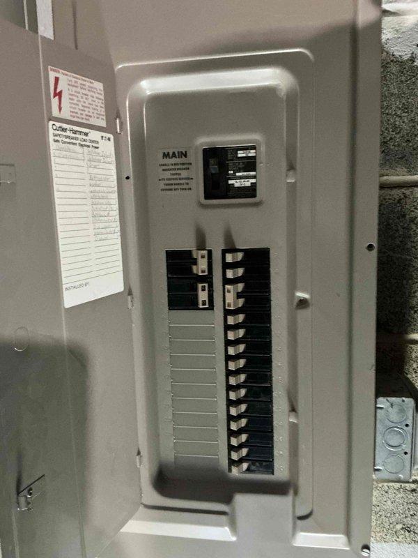 Completed on-site evaluation for standby generator installation at residential property. Assessed existing electrical infrastructure including main service panel with Cutler-Hammer equipment and exterior meter assembly with General Electric kilowatt-hour meter. Documented current electrical configuration, panel capacity, and service entrance conditions to determine generator sizing requirements, transfer switch placement options, and integration specifications for automatic backup power system.