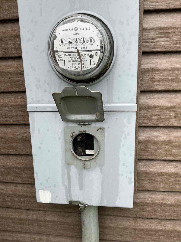 Completed on-site evaluation for standby generator installation at residential property. Assessed existing electrical infrastructure including main service panel with Cutler-Hammer equipment and exterior meter assembly with General Electric kilowatt-hour meter. Documented current electrical configuration, panel capacity, and service entrance conditions to determine generator sizing requirements, transfer switch placement options, and integration specifications for automatic backup power system.