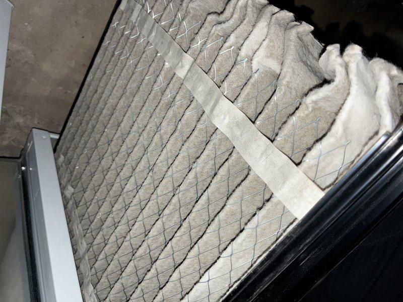 Completed recurring maintenance service on HVAC heating system. Inspected and documented air filter condition, noting pleated media with diagonal chevron pattern and securing tape in place. Examined control board assembly, verifying proper connections of multiple circuit boards with various electronic components, wire harnesses, and connector blocks all functioning within normal parameters.