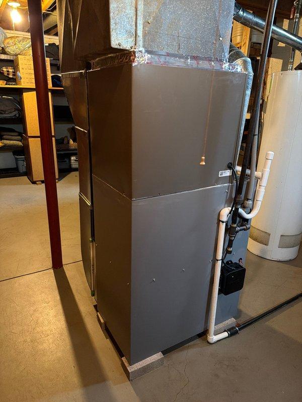 Completed installation of new air conditioning evaporator coil on existing furnace system in residential basement. Unit was properly mounted, refrigerant lines connected, condensate drain plumbing installed with pump system, and all ductwork transitions sealed and secured. System tested and confirmed operational with proper airflow and drainage.