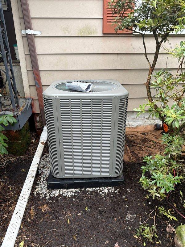Completed full HVAC system installation including outdoor condenser unit and electrical disconnect components. Installed 90% efficiency air conditioning condenser on level pad with proper gravel base and positioning against exterior wall for optimal airflow and serviceability. Mounted and wired electrical disconnect box with appropriately rated Littelfuse fuses to ensure proper overcurrent protection and code compliance. Verified all electrical connections, tested system operation, and confirmed unit is functioning within manufacturer specifications.
