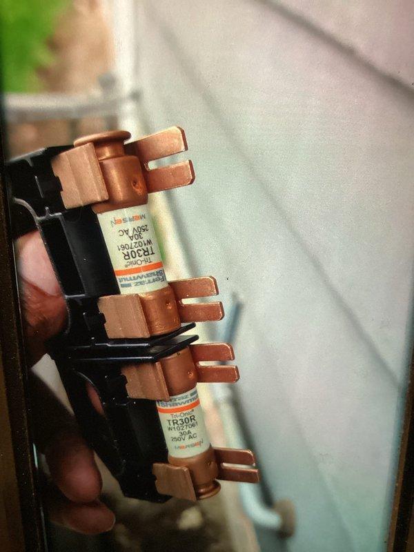 Completed comprehensive AC tune-up and maintenance inspection on cooling system. Verified electrical components including TR30R fuses rated at 600V AC, confirming proper amperage ratings and secure connections within the disconnect panel. Inspected ductwork assembly and metal panels in mechanical space, noting all components properly fitted and secured with minor dust accumulation typical of normal operation.