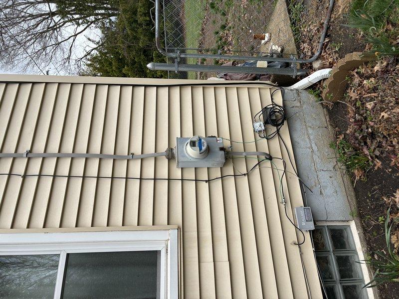 Conducted comprehensive electrical safety inspection and assessment of existing main electrical panel in basement. Panel identified as original to home construction, requiring evaluation for replacement due to age and current electrical code compliance. Documented exterior service entrance components, including weatherhead connections, service mast, and meter base configuration. Evaluated overhead service drop connections and exterior conduit routing along building envelope. Assessed panel capacity, breaker conditions, and overall system integrity to determine replacement specifications and scope of work required for modern electrical service upgrade.