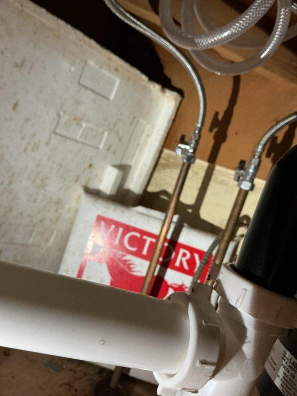 Installed customer-supplied kitchen faucet fixture on double-basin stainless steel sink. Connected braided flexible supply lines to existing copper water supply pipes and verified proper water flow and drainage with no leaks detected upon completion.