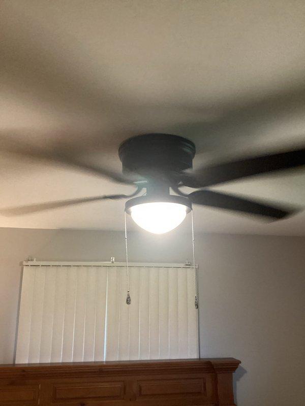 Installed customer-supplied ceiling fan with integrated light fixture and replaced existing switch wiring to ensure proper operation. Verified all electrical connections, tested both fan and light functions via pull chain controls, and confirmed safe installation with no operational issues.