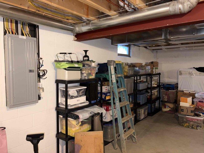 Conducted on-site electrical assessment for backup generator installation in residential basement utility area. Evaluated existing 200-amp main electrical panel, documented current circuit configuration, and photographed service entrance wiring and available mounting locations. Assessed basement infrastructure including ceiling clearances, ductwork routing, and wall space for potential automatic transfer switch placement. Identified suitable conduit pathways from main panel to proposed generator location and verified adequate clearances per NEC requirements for generator installation.
