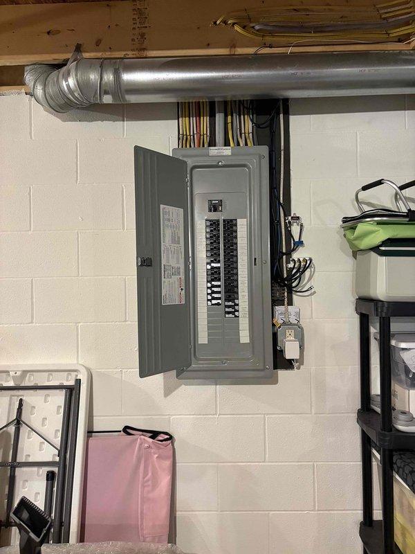 Conducted on-site electrical assessment for backup generator installation in residential basement utility area. Evaluated existing 200-amp main electrical panel, documented current circuit configuration, and photographed service entrance wiring and available mounting locations. Assessed basement infrastructure including ceiling clearances, ductwork routing, and wall space for potential automatic transfer switch placement. Identified suitable conduit pathways from main panel to proposed generator location and verified adequate clearances per NEC requirements for generator installation.