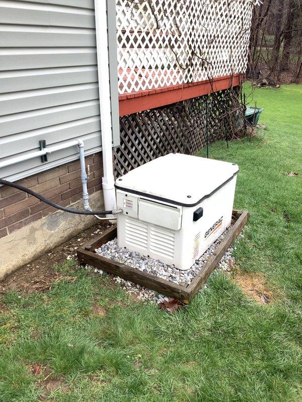Responded to service call for 7-year-old Generac residential standby generator experiencing over-crank alarm and failure to start. Upon arrival, performed diagnostic assessment of unit installed on wooden platform base with proper gravel drainage. Inspected generator control panel, battery connections, and starting system components. Identified low battery voltage as primary cause preventing successful engine cranking sequence. Tested battery charging system and confirmed charging circuit functionality. Replaced failed battery with manufacturer-specified replacement unit and verified proper voltage output. Cycled generator through multiple start sequences to confirm restoration of normal operation. Cleared over-crank fault code from control module. Performed routine maintenance inspection including oil level verification, air filter condition check, and visual inspection of fuel lines and electrical conduit connections. Verified proper operation of transfer switch and load bank functio