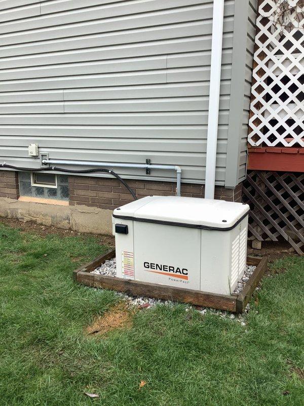 Responded to service call for 7-year-old Generac residential standby generator experiencing over-crank alarm and failure to start. Upon arrival, performed diagnostic assessment of unit installed on wooden platform base with proper gravel drainage. Inspected generator control panel, battery connections, and starting system components. Identified low battery voltage as primary cause preventing successful engine cranking sequence. Tested battery charging system and confirmed charging circuit functionality. Replaced failed battery with manufacturer-specified replacement unit and verified proper voltage output. Cycled generator through multiple start sequences to confirm restoration of normal operation. Cleared over-crank fault code from control module. Performed routine maintenance inspection including oil level verification, air filter condition check, and visual inspection of fuel lines and electrical conduit connections. Verified proper operation of transfer switch and load bank functio