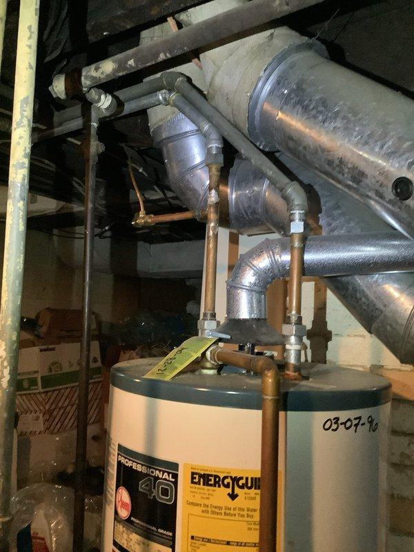 Responded to low water flow issue affecting both hot and cold water at kitchen faucet. Inspected chrome pull-down faucet at double-basin stainless steel sink and determined aerator was clogged with mineral deposits and debris. Removed and cleaned aerator, restoring full water pressure to both hot and cold lines.