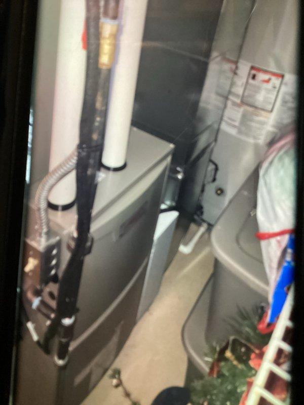 Responded to customer complaint of banging noise in ductwork during operation on recently installed natural gas furnace. Performed multi-point visual inspection of system and ductwork components. Upon examination, observed evidence of potential ductwork expansion/contraction issues common with new installations. Verified furnace operation and airflow patterns. Documented system conditions with photographs showing furnace cabinet interior, PVC venting configuration, and ductwork panels with visible wear patterns. No adjustments required at this time.