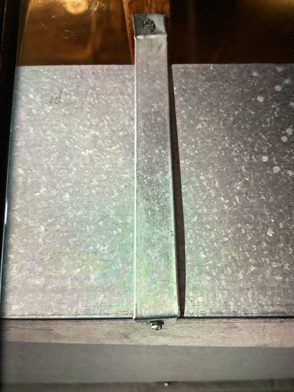 Responded to customer complaint of banging noise in ductwork during operation on recently installed natural gas furnace. Performed multi-point visual inspection of system and ductwork components. Upon examination, observed evidence of potential ductwork expansion/contraction issues common with new installations. Verified furnace operation and airflow patterns. Documented system conditions with photographs showing furnace cabinet interior, PVC venting configuration, and ductwork panels with visible wear patterns. No adjustments required at this time.