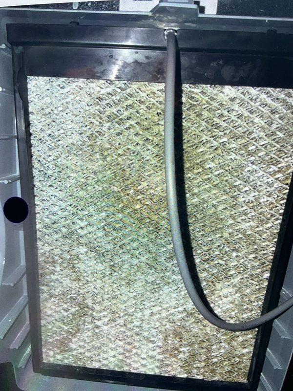 Completed scheduled cooling maintenance on 9-year-old Lennox HVAC system. Performed comprehensive inspection of furnace, ductwork, and Aprilaire air cleaner unit located in basement mechanical room. Identified heavily contaminated air filter with significant dirt and debris accumulation showing yellow, green, and brown discoloration throughout the mesh material. Replaced soiled filter to restore proper airflow and system efficiency. Verified all ductwork connections and seals were intact with no visible air leaks. System operational and ready for continued cooling season performance.